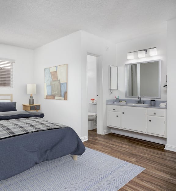 an empty room with a bathroom in the background