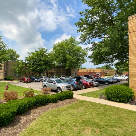 a parking lot with cars parked in front of a building
