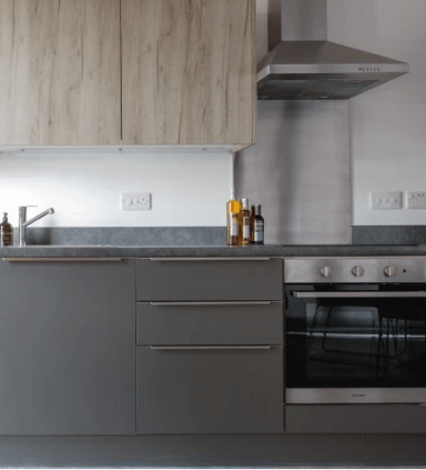 a kitchen with an oven and a sink at Vox Apartments, Manchester