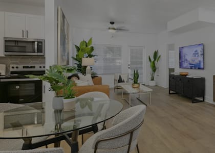 A modern kitchen with a glass table and chairs.