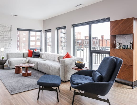 a living room with a white couch and blue chairs