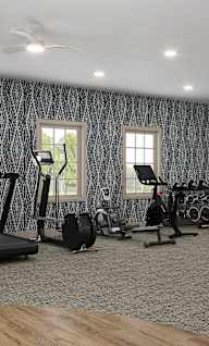 A spacious home gym with a variety of exercise equipment.