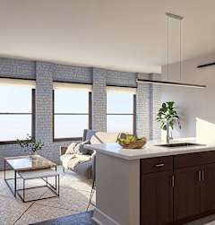 A modern kitchen with a white countertop and a brick wall at The Carousel, Virginia 23220