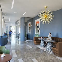 a reception area with a large screen tv on the wall and a long counter with stools