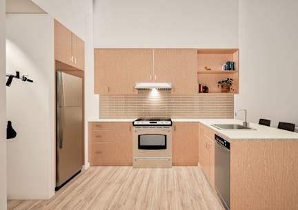 A modern kitchen with wooden cabinets and stainless steel appliances.