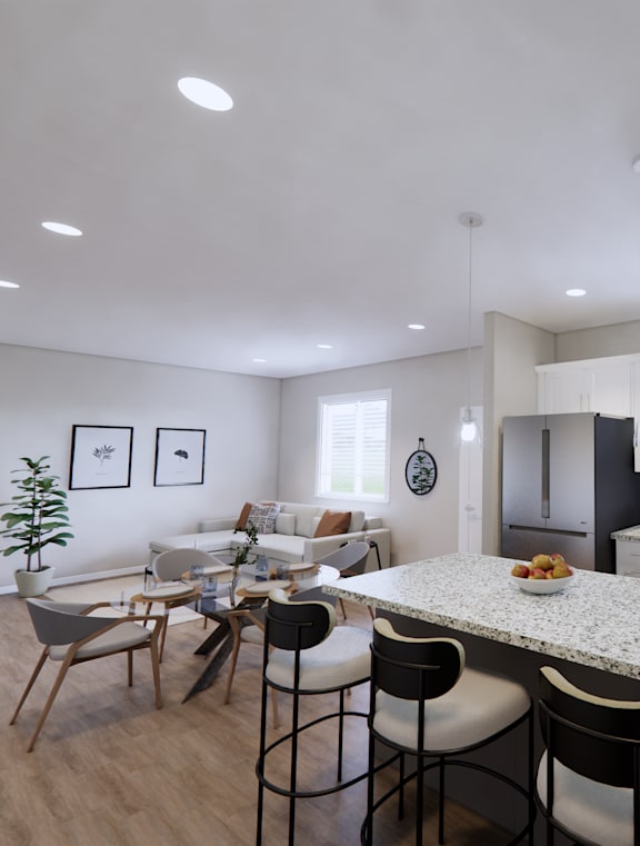 A modern kitchen with a dining table and chairs.