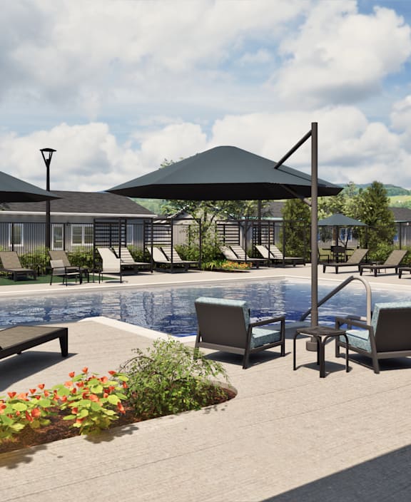 Two black chairs are placed on a patio in front of a pool.