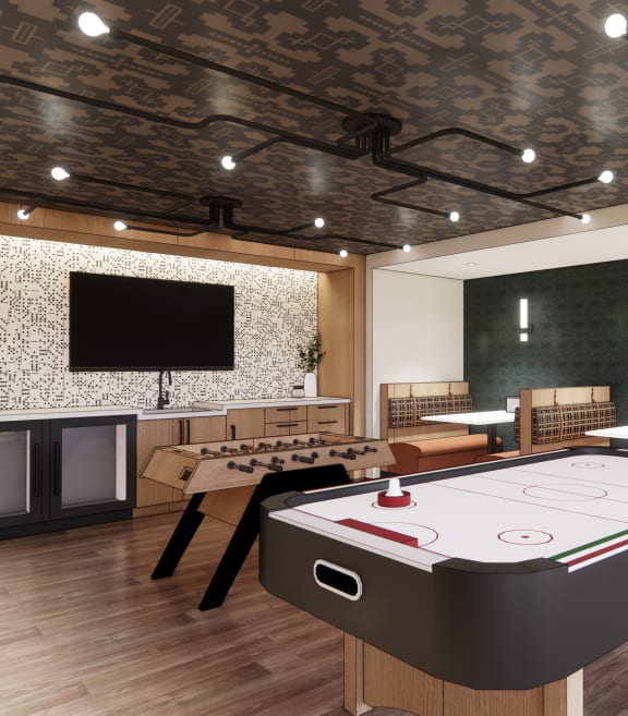 a games room with a foosball table and a tv