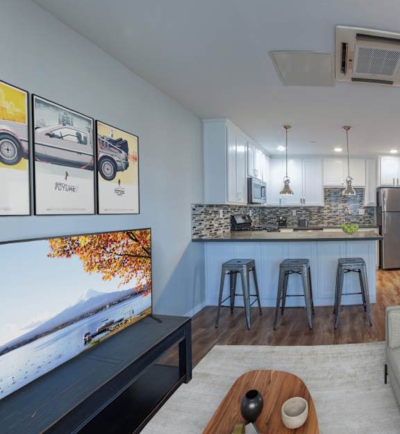 A modern living room with a staircase leading to the upper level.