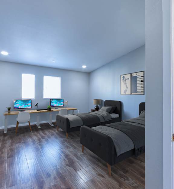A room with a bed, desk, and chair.