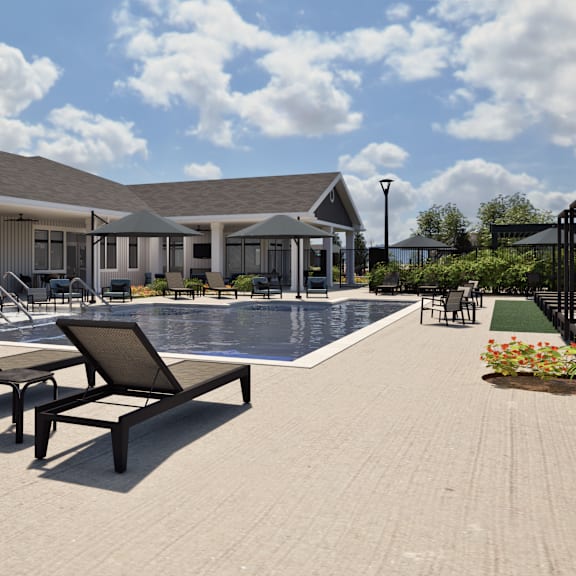 A pool area with a building and loungers.