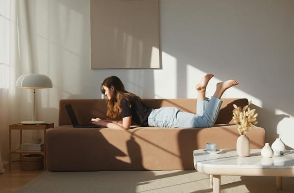 a woman lying on a couch at 505 Collection in Atlanta 30305
