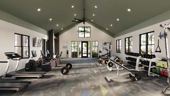 A gym with a variety of equipment including treadmills, weights, and a ceiling fan.
