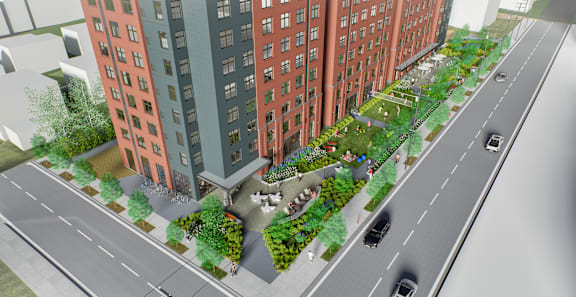 A street view of a city with cars and buildings. at University Commons in Pittsburgh, PA