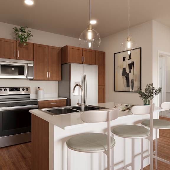 A modern kitchen with wooden cabinets and white countertops.at The Landing at Hub City, Wisconsin