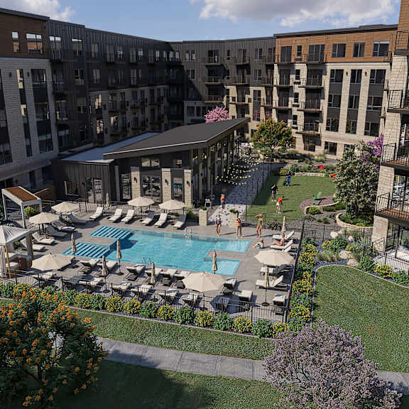 A large outdoor pool surrounded by lounge chairs and umbrellas.