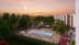 an aerial view of a hotel with a pool and trees