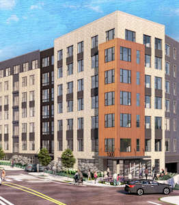 A modern building with a parking lot in front of it.