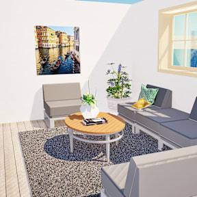 A living room with a grey couch, a coffee table, and a painting on the wall.