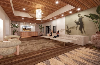 A modern living room with a wooden floor and ceiling, a large rug, and a mural on the wall.