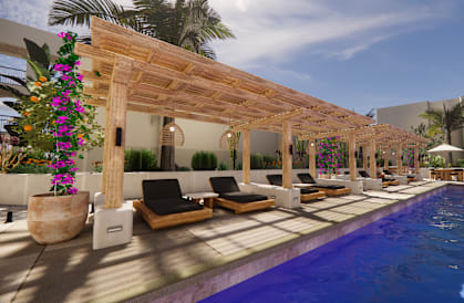 A pool area with a wooden pergola and lounge chairs.