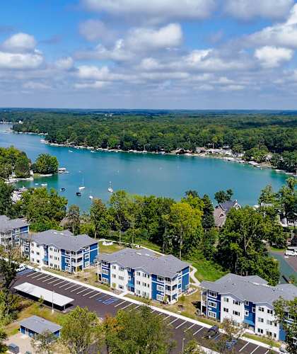 arial view of apartments with a lake in the background