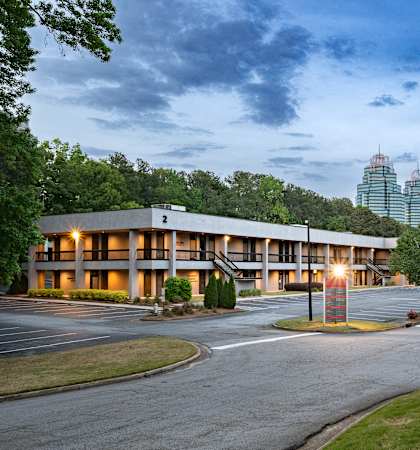 A large building with a parking lot in front of it.