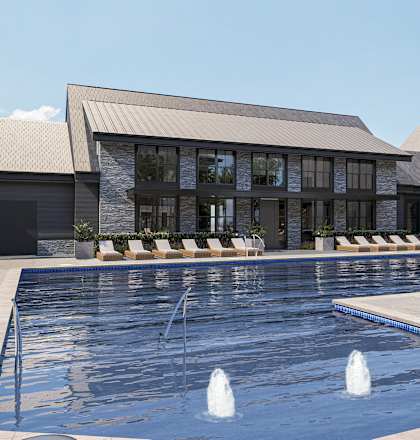 A large swimming pool in front of a building with a palm tree to the side.