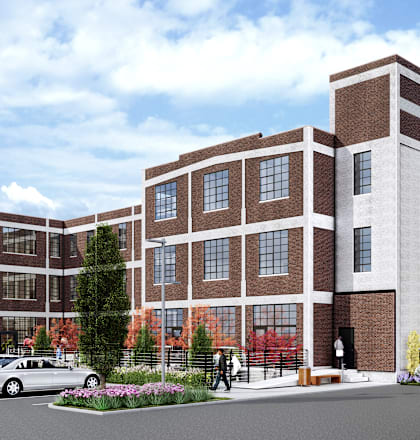 A modern building with a parking lot in front.