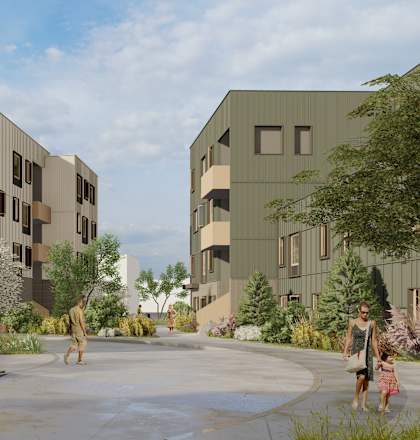 A modern building complex with a courtyard and people walking.