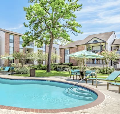 A swimming pool in front of apartment buildings.