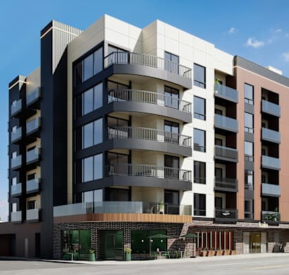 A modern multi-story apartment building with balconies and a mix of brick and panel exterior.