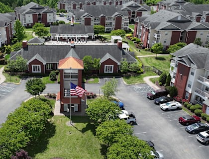 A bird's eye view of a residential area with houses and cars.