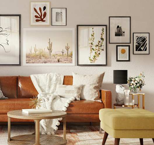 a living room with a brown couch and pictures on the wall