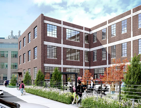 A modern building with a red brick facade and large windows.
