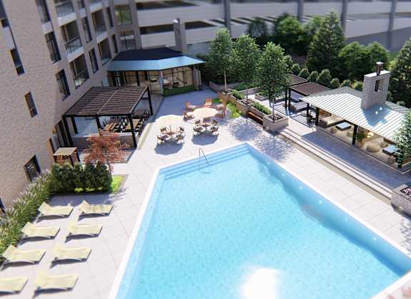 A pool surrounded by trees and a building.