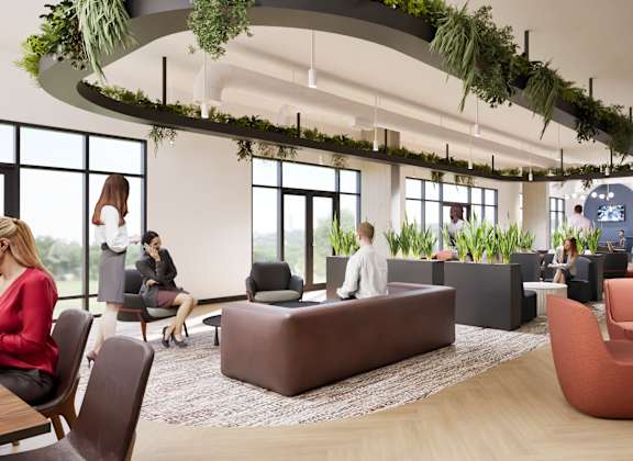 A modern office space with people working and sitting around.