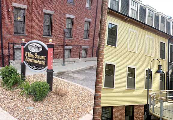 A sign for 9 May Street is in front of a building.