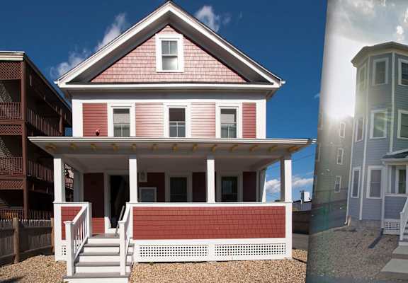 A red house with white trim and a porch.