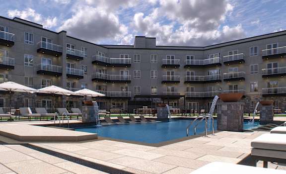 a large pool with chairs and umbrellas in front of a hotel building at 2274 Princess St., Ontario