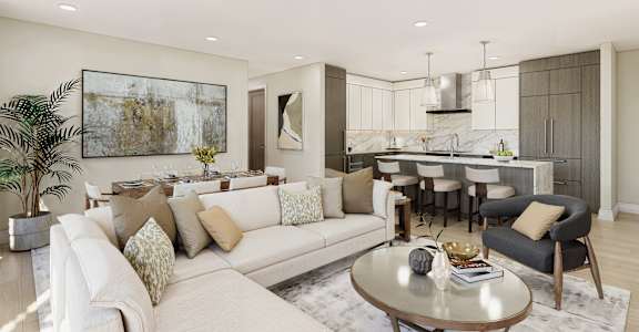 A modern living room with a white sofa, a coffee table, and a kitchen area in the background.