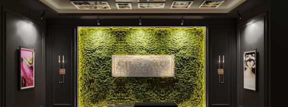 A green leafy wall with a white sign in the middle of it. at Chateau on Wells, Chicago, Illinois
