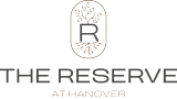 A logo with a tree and roots in a shield shape with the words "The Reserve at Hanover" below it.