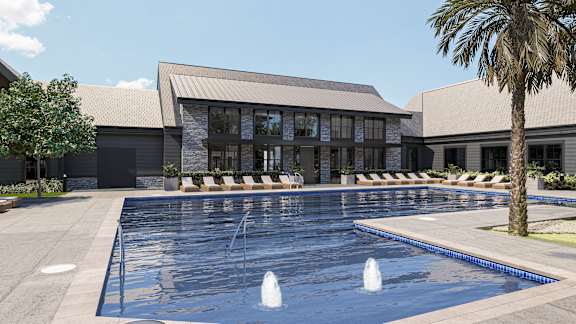 A large swimming pool in front of a building with a palm tree to the side at The Pullman Luxury Apartment Homes, Atlanta, Georgia