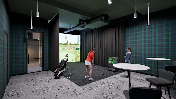 A woman in an orange top is playing golf in a room with a screen showing a golf course.
