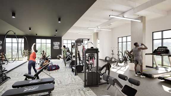 A gym with people working out and various exercise equipment.