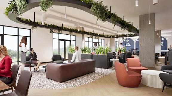 A modern office space with people working and sitting around.
