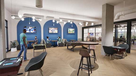 A modern office space with blue walls and wooden floors.