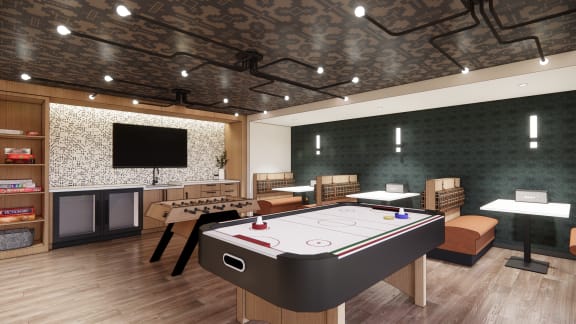 a games room with a foosball table and a tv