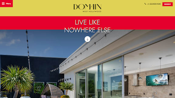 A modern house with a sign that says "DOMAIN WEST HOLLYWOOD" and a phone number.